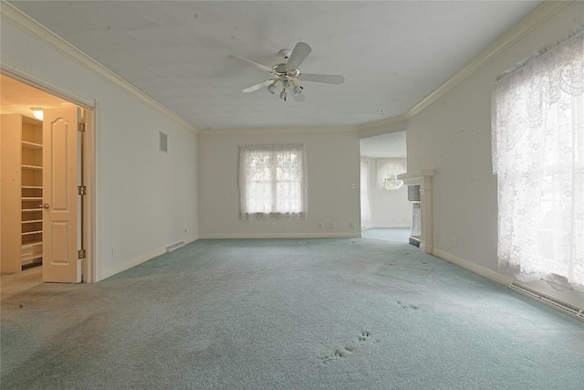 spare room featuring light carpet, ceiling fan, and ornamental molding