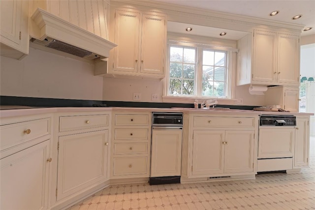 kitchen with dishwasher, premium range hood, and white cabinetry