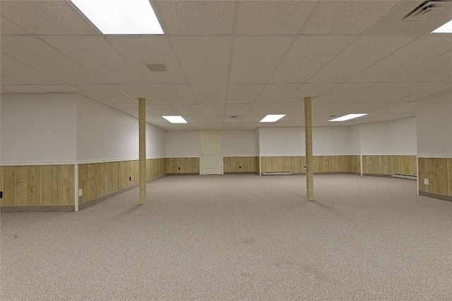 basement featuring baseboard heating and light colored carpet