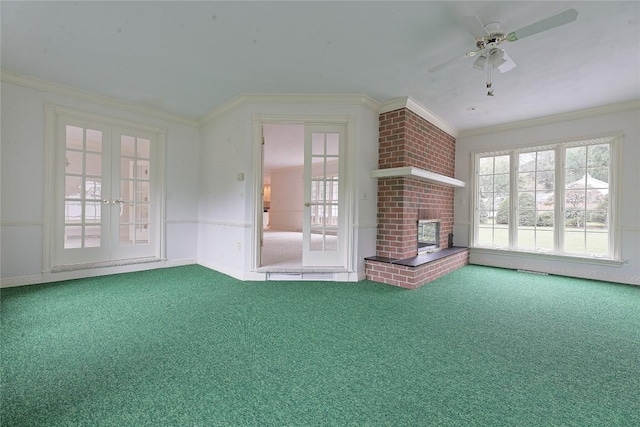 unfurnished living room with a fireplace, ceiling fan, french doors, and crown molding