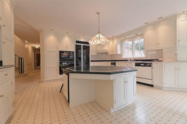 kitchen featuring black appliances, a kitchen island, white cabinets, and pendant lighting