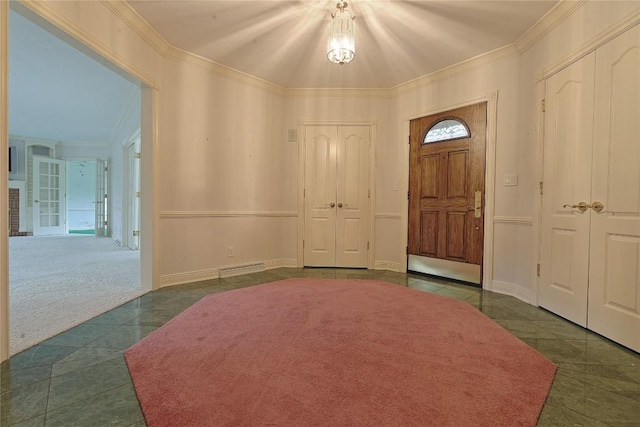 entrance foyer with dark tile patterned floors