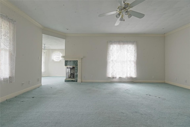 unfurnished living room featuring light carpet, crown molding, ceiling fan, and a premium fireplace