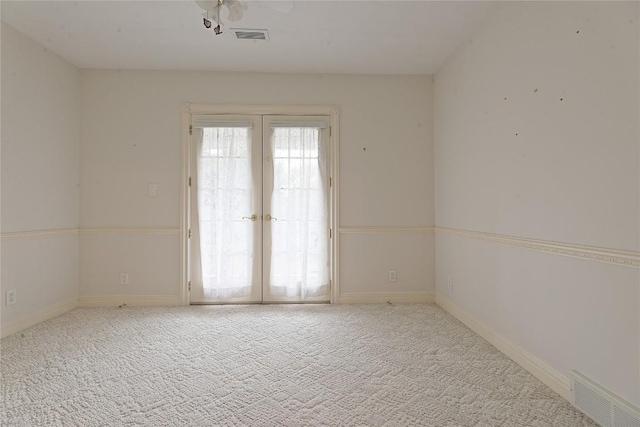 carpeted empty room with french doors