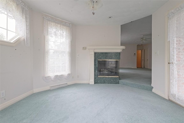 unfurnished living room featuring carpet flooring, a fireplace, and ceiling fan