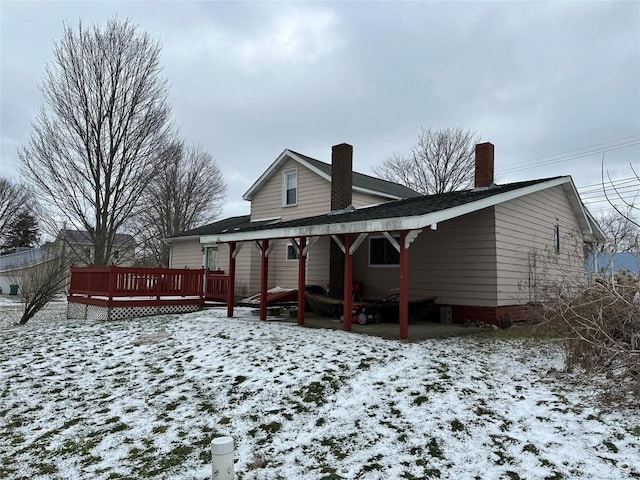 snow covered property featuring a wooden deck