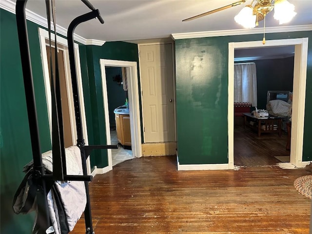 interior space with ornamental molding and wood finished floors