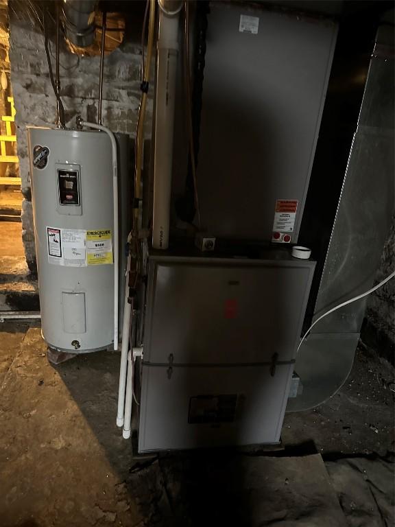 utility room featuring electric water heater and heating unit