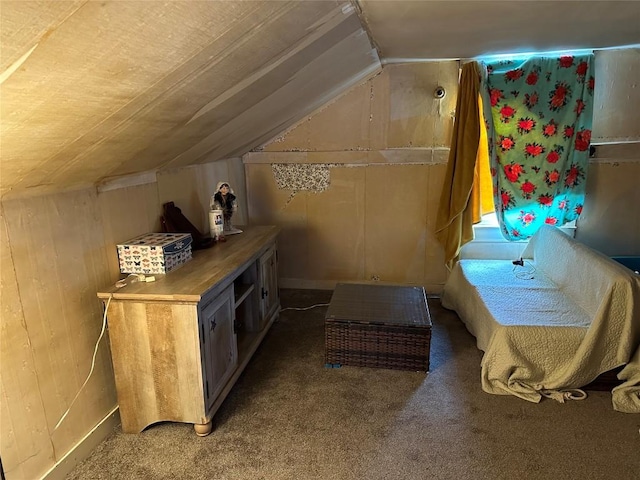 bonus room featuring carpet, wooden walls, and vaulted ceiling