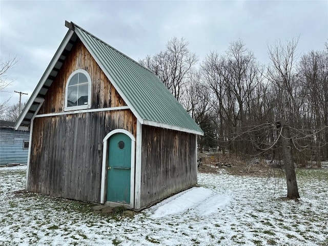 snow covered structure with an outdoor structure