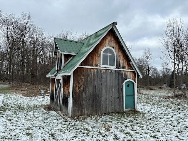 snow covered structure featuring an outdoor structure