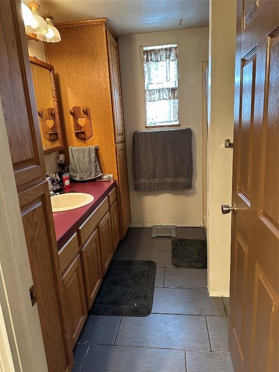 bathroom featuring tile patterned flooring and vanity