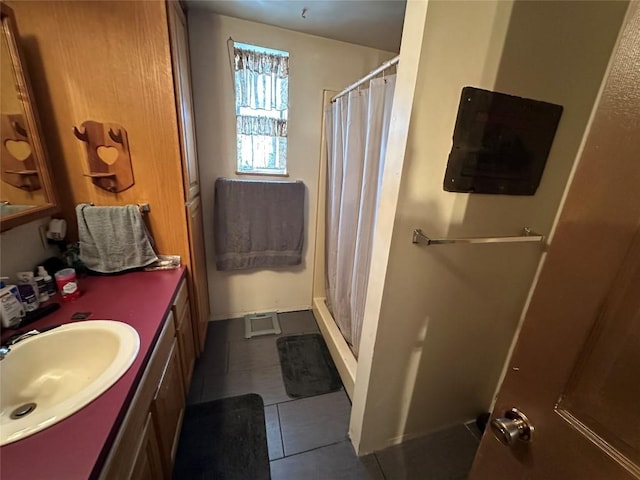 full bathroom featuring tile patterned flooring, a shower stall, and vanity