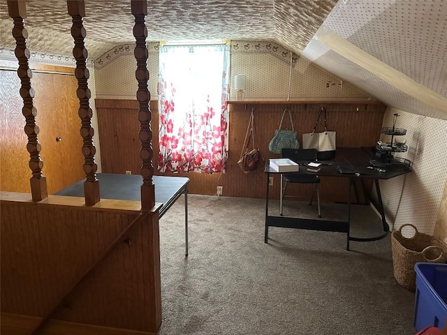 carpeted office space with vaulted ceiling