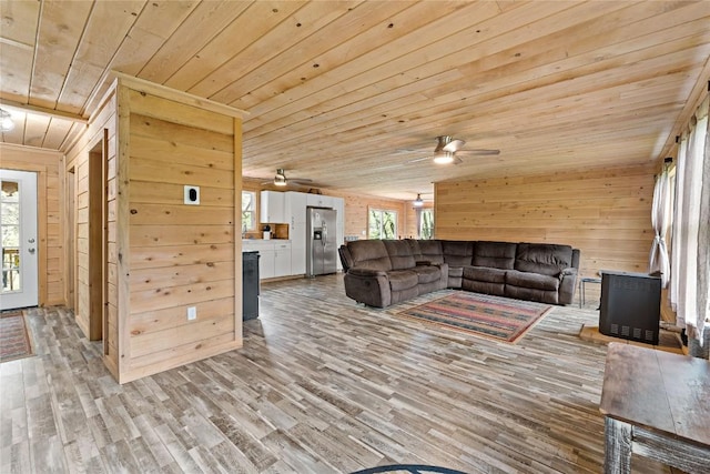 2629 River Dr, Jamestown, PA 16134 - living room with wooden ceiling, wood walls, ceiling fan, and light wood-type flooring