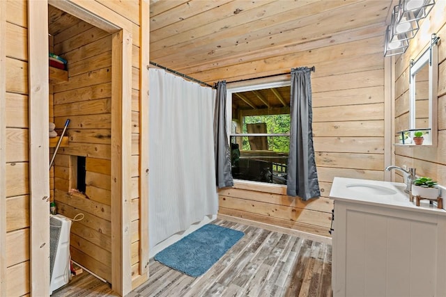2629 River Dr, Jamestown, PA 16134 - bathroom with wooden walls, wood finished floors, vanity, and wooden ceiling