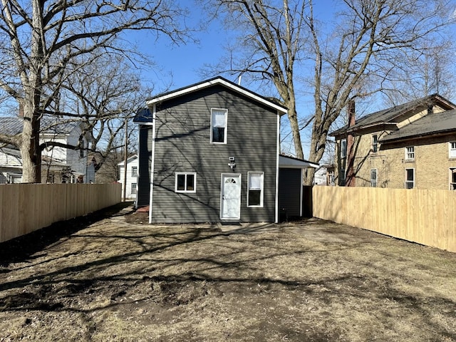 back of house featuring fence