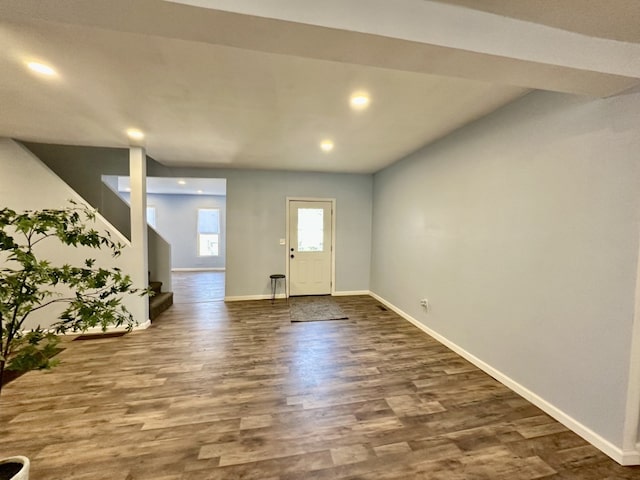 foyer entrance featuring stairway, recessed lighting, baseboards, and dark wood-style flooring