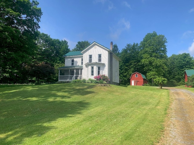 5511 Lake Rd, Atlantic, PA 16111 - back of house with a sunroom, a chimney, a barn, a yard, and an outdoor structure