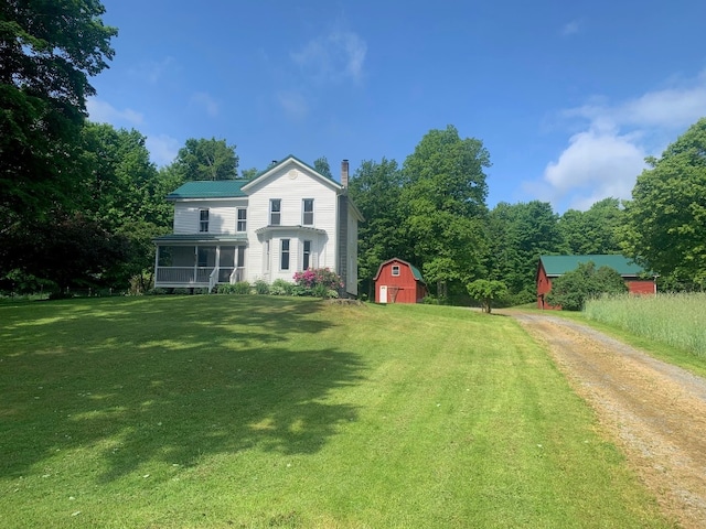 5511 Lake Rd, Atlantic, PA 16111 - view of green lawn featuring an outdoor structure, a sunroom, driveway, and a barn