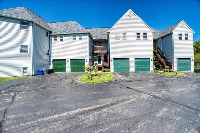 634 W 2nd St Unit 306, Erie, PA 16507 - view of front facade with an attached garage, driveway, and stairs