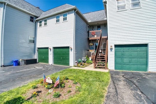 634 W 2nd St Unit 306, Erie, PA 16507 - view of front of home with an attached garage, driveway, stairs, and roof with shingles