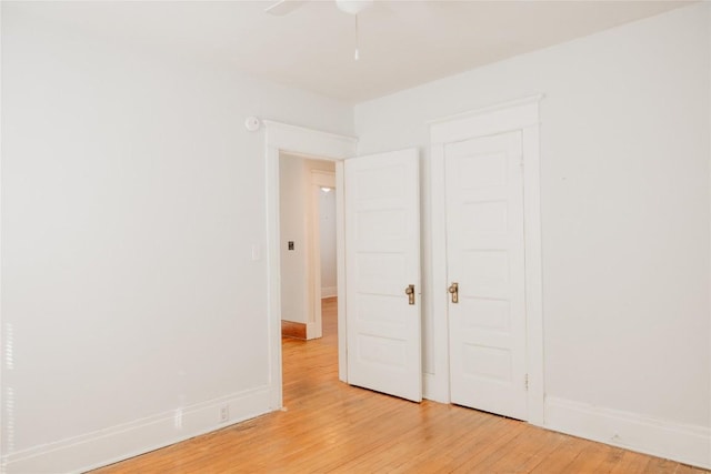 unfurnished bedroom with ceiling fan and light wood-type flooring