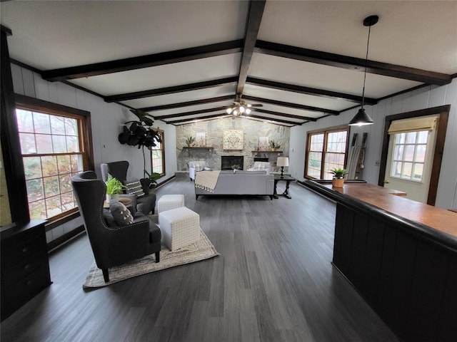 living room with a fireplace, vaulted ceiling with beams, dark hardwood / wood-style flooring, and ceiling fan