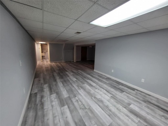 basement with hardwood / wood-style floors and a drop ceiling