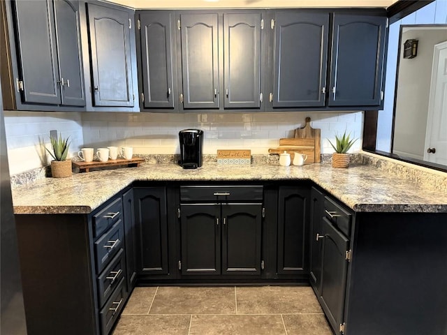 kitchen featuring tile patterned floors and backsplash