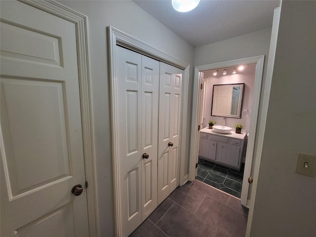 bathroom featuring tile patterned flooring, a textured ceiling, and vanity