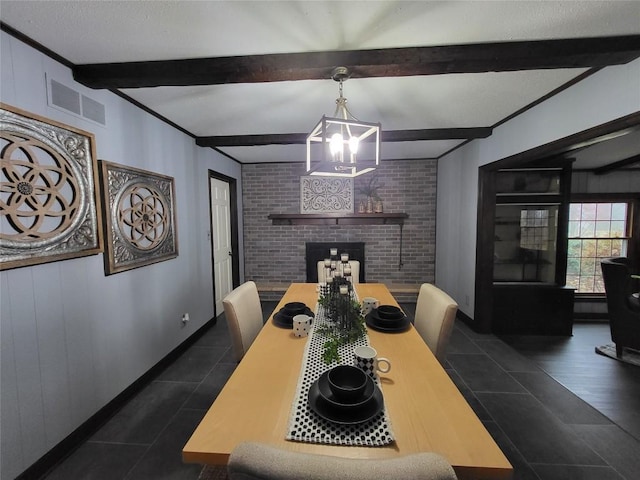 dining area with a chandelier, beam ceiling, and a brick fireplace