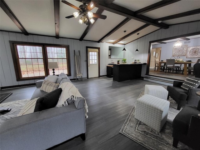 living room featuring vaulted ceiling with beams, dark hardwood / wood-style floors, and ceiling fan with notable chandelier