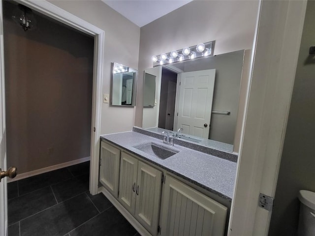 bathroom featuring tile patterned floors, vanity, and toilet