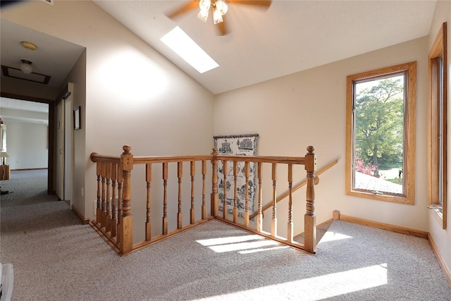 bonus room featuring light colored carpet, lofted ceiling with skylight, and ceiling fan