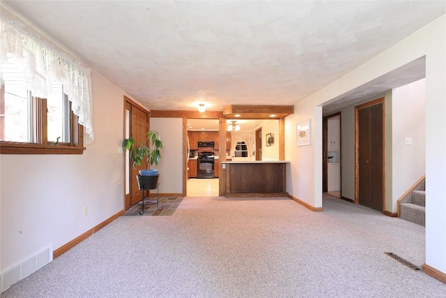 unfurnished living room featuring light colored carpet