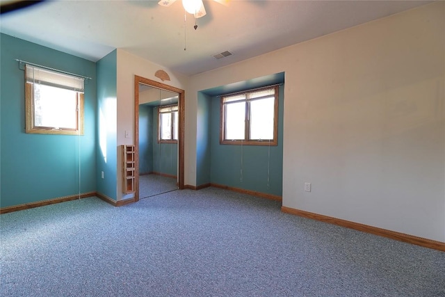 unfurnished bedroom featuring ceiling fan, a closet, and carpet floors