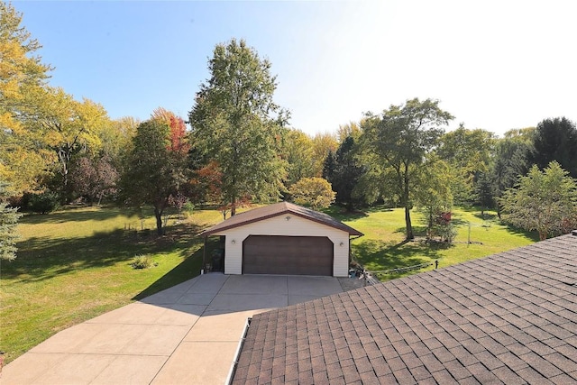 exterior space featuring a yard, an outdoor structure, and a garage