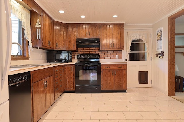 kitchen with black appliances, sink, ornamental molding, tasteful backsplash, and extractor fan