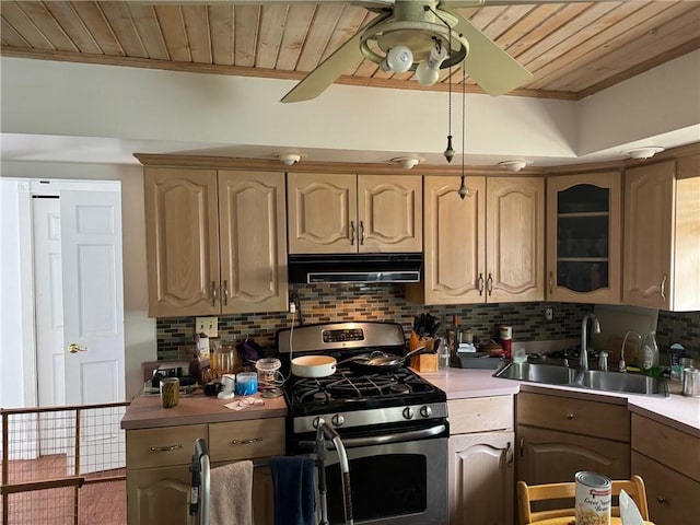 kitchen featuring tasteful backsplash, sink, ceiling fan, and stainless steel gas stove