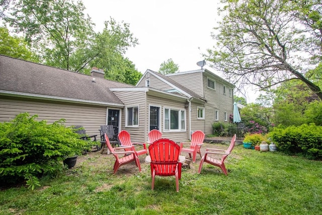 104 Hillcrest Dr, Edinboro, PA 16412 - back of property with a yard, a chimney, and an outdoor fire pit