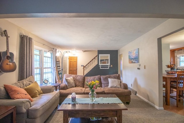104 Hillcrest Dr, Edinboro, PA 16412 - carpeted living area featuring stairway and baseboards