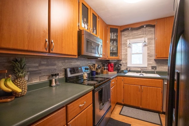104 Hillcrest Dr, Edinboro, PA 16412 - kitchen featuring stainless steel appliances, a sink, tasteful backsplash, and brown cabinets