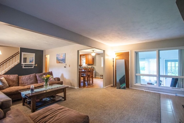 104 Hillcrest Dr, Edinboro, PA 16412 - living area with a baseboard radiator, stairway, and baseboards