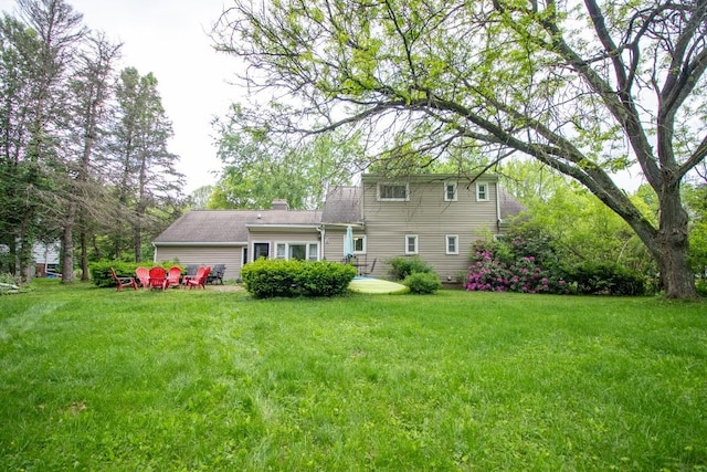 104 Hillcrest Dr, Edinboro, PA 16412 - rear view of house with a chimney and a lawn