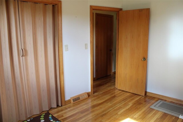 unfurnished bedroom featuring light wood-type flooring