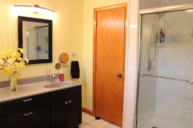 bathroom with tile patterned flooring, vanity, and an enclosed shower