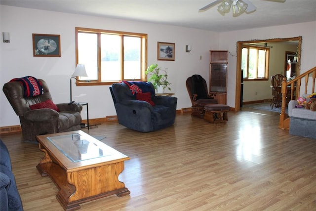 living room with light hardwood / wood-style flooring and ceiling fan