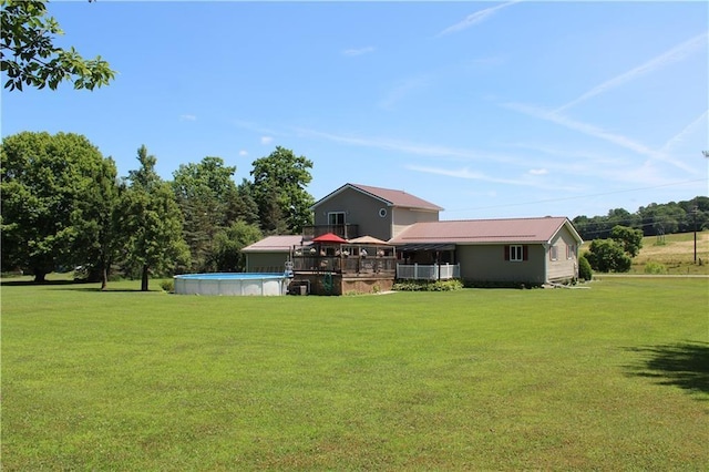 rear view of house featuring a lawn