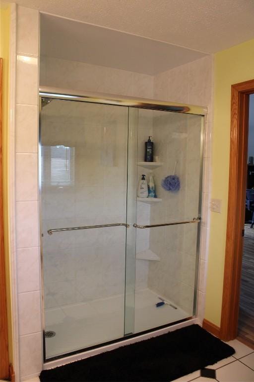 bathroom with tile patterned flooring and an enclosed shower